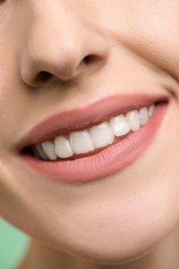 girl smiling with invisalign from queens cosmetic dentist
