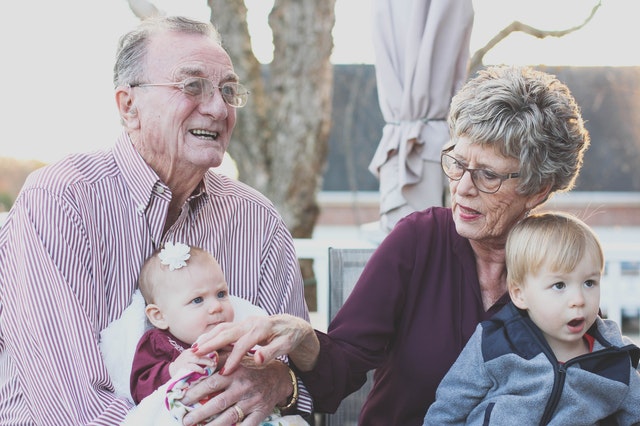 elderly couple with family